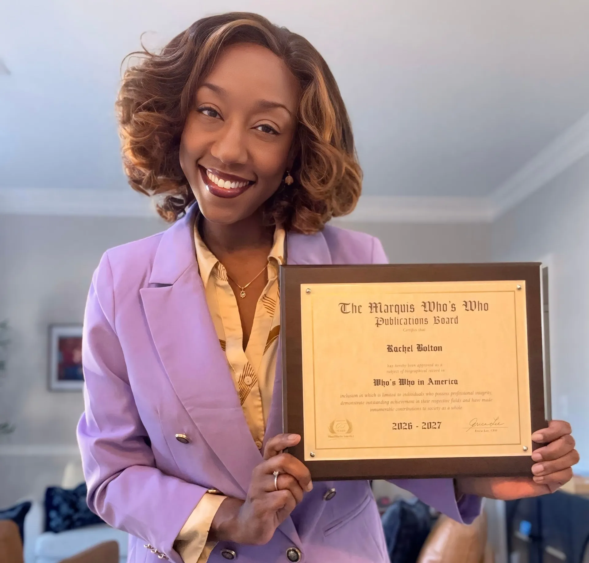 Rachel Bolton holding her Marquis Who's Who plaque